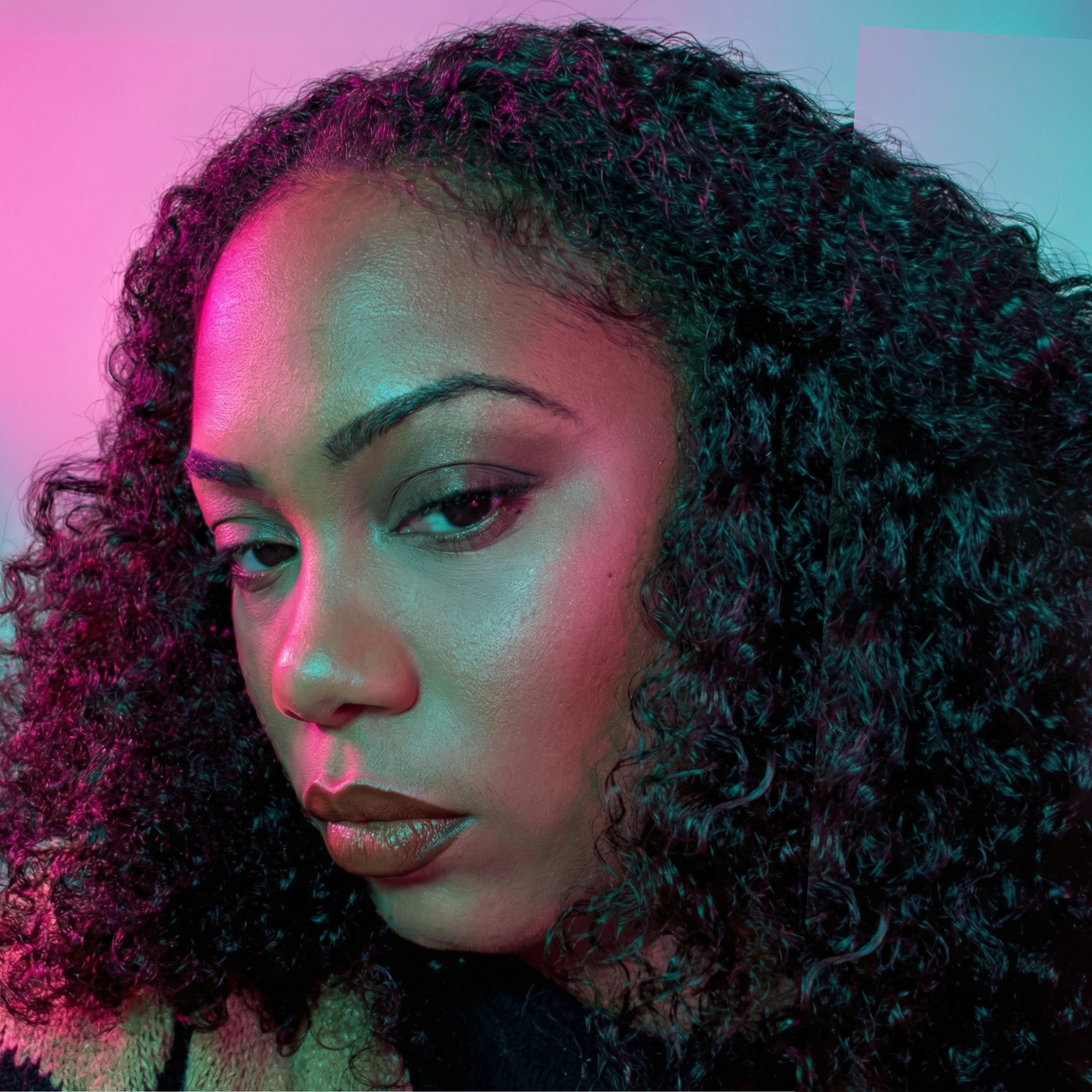 Woman with curly hair under pink and blue lighting