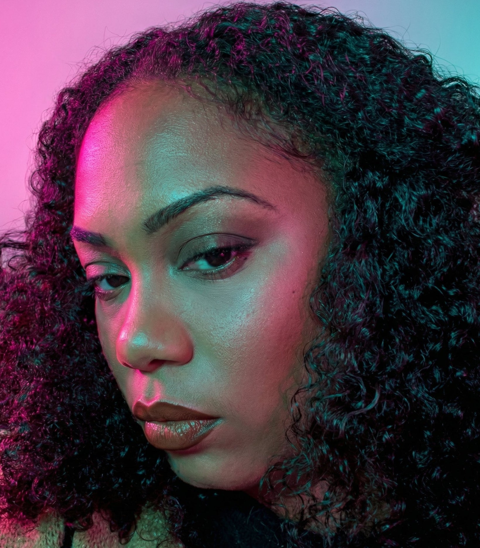 Woman with curly hair against a colorful gradient background with 'Tashemachanel Cosmetics' branding.